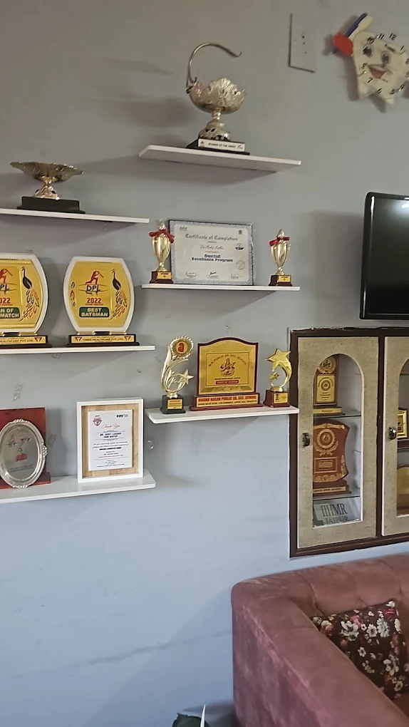Awards and trophies displayed on shelves at Your Dentist, Malviya Nagar, Jaipur