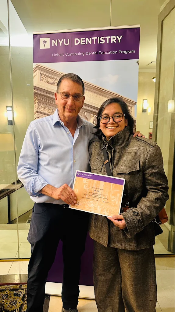 Dr. Ruby Ladha receiving a training certificate at a dental education programme