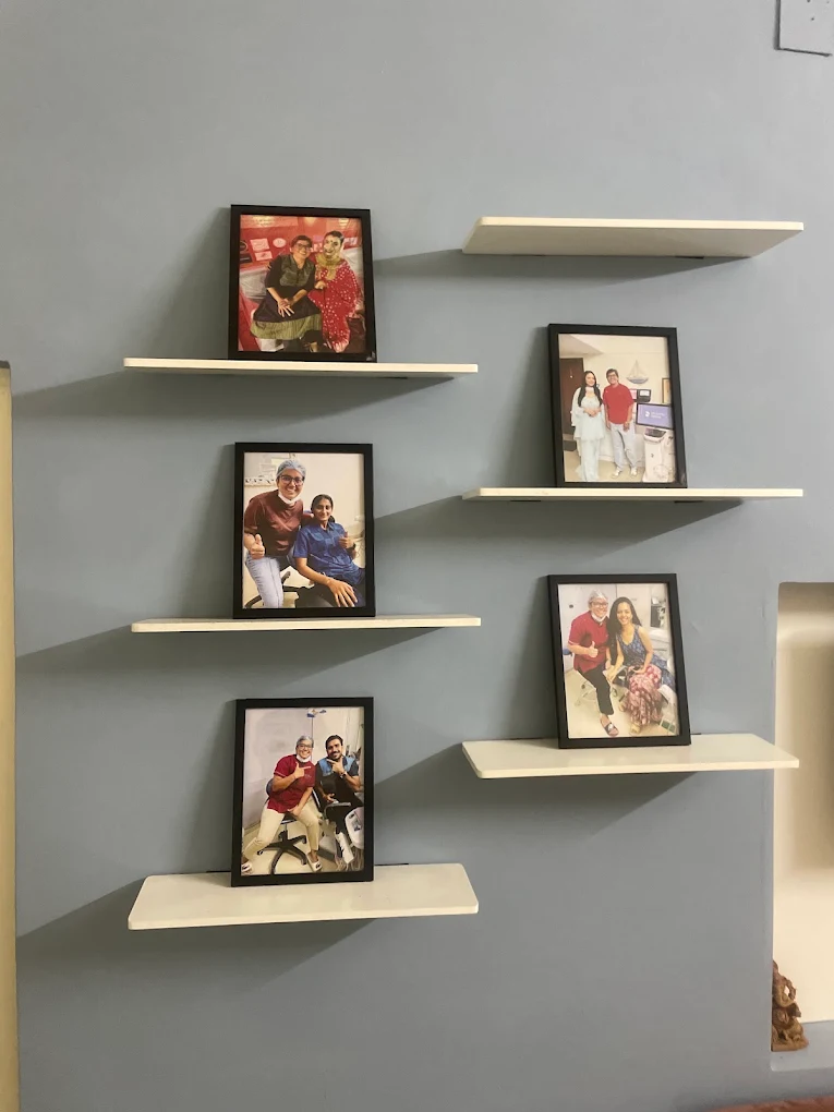 Framed photos of happy patients displayed on the wall at Your Dentist, Malviya Nagar, Jaipur