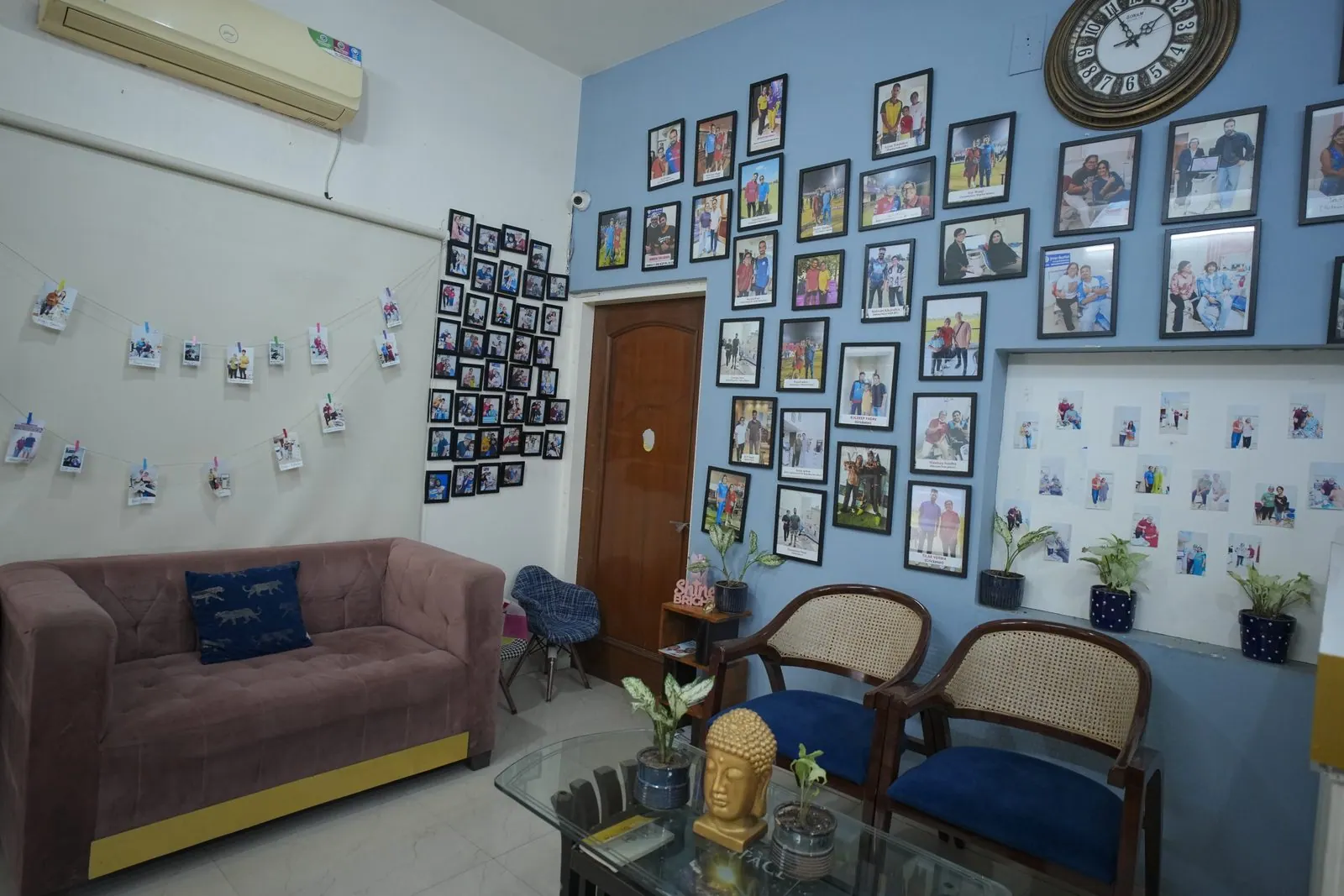Waiting area with a sofa and patient photo wall at Your Dentist, Malviya Nagar, Jaipur