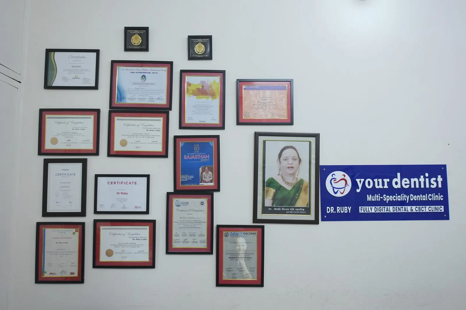 Framed certificates and awards on the clinic wall at Your Dentist, Malviya Nagar, Jaipur