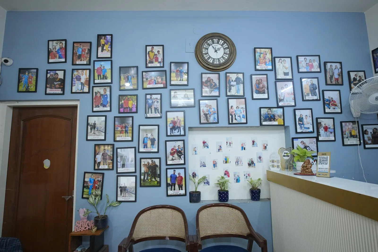 Wall of framed patient photos at Your Dentist, Malviya Nagar, Jaipur